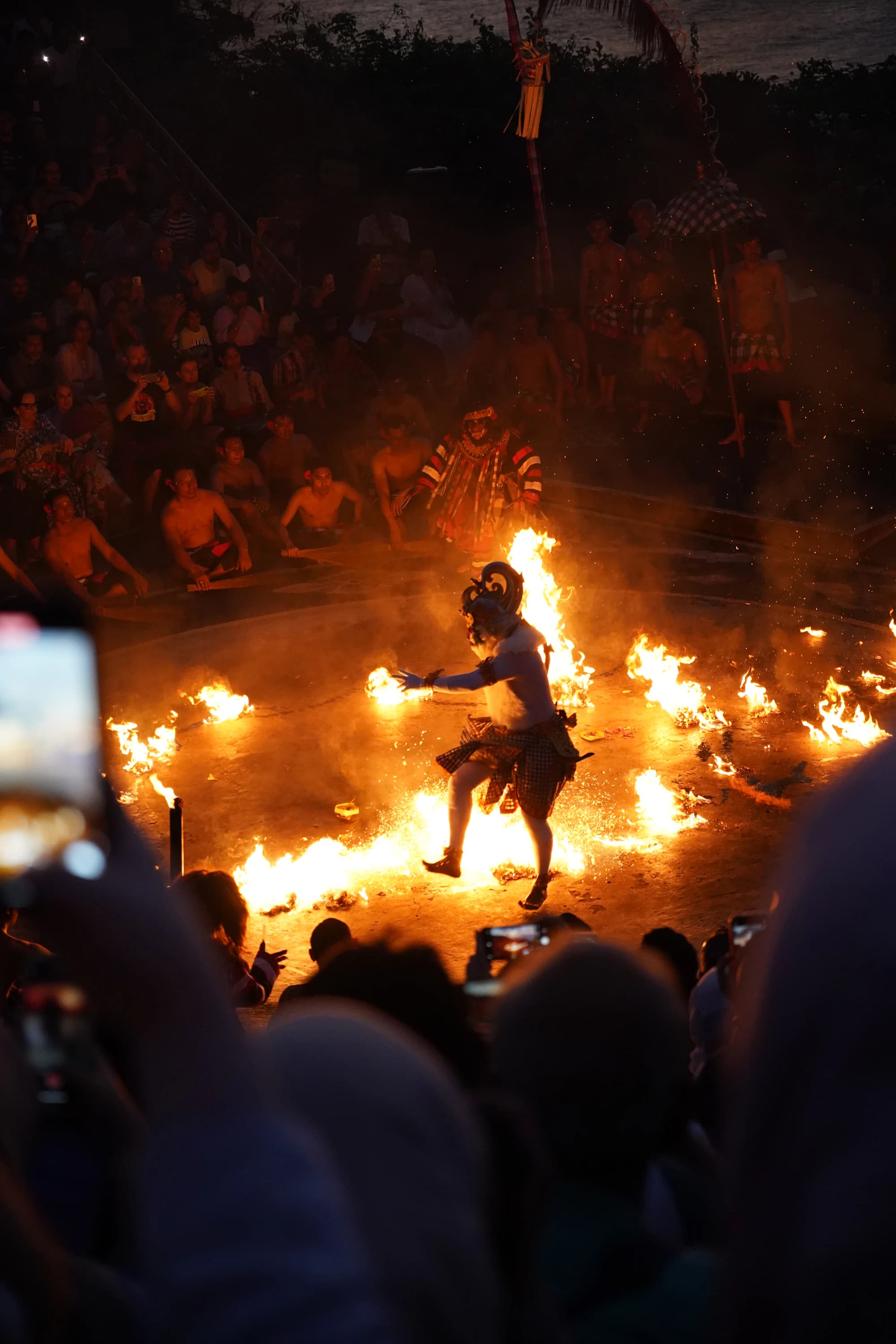 A Balinese dancer leaping through fire during a Kecak performance