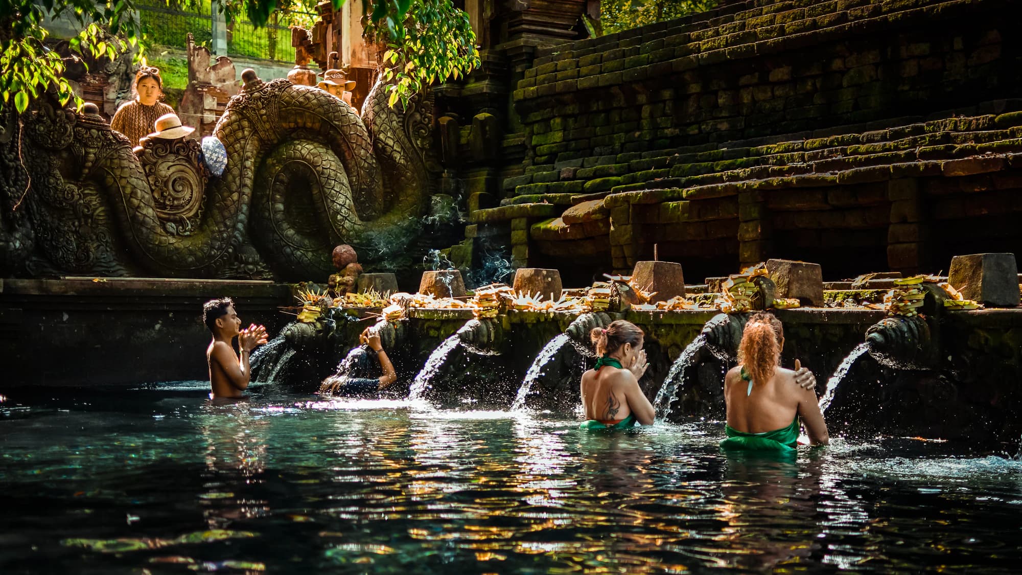 Bathers under the spouts of the holy spring at Tirta Empul temple