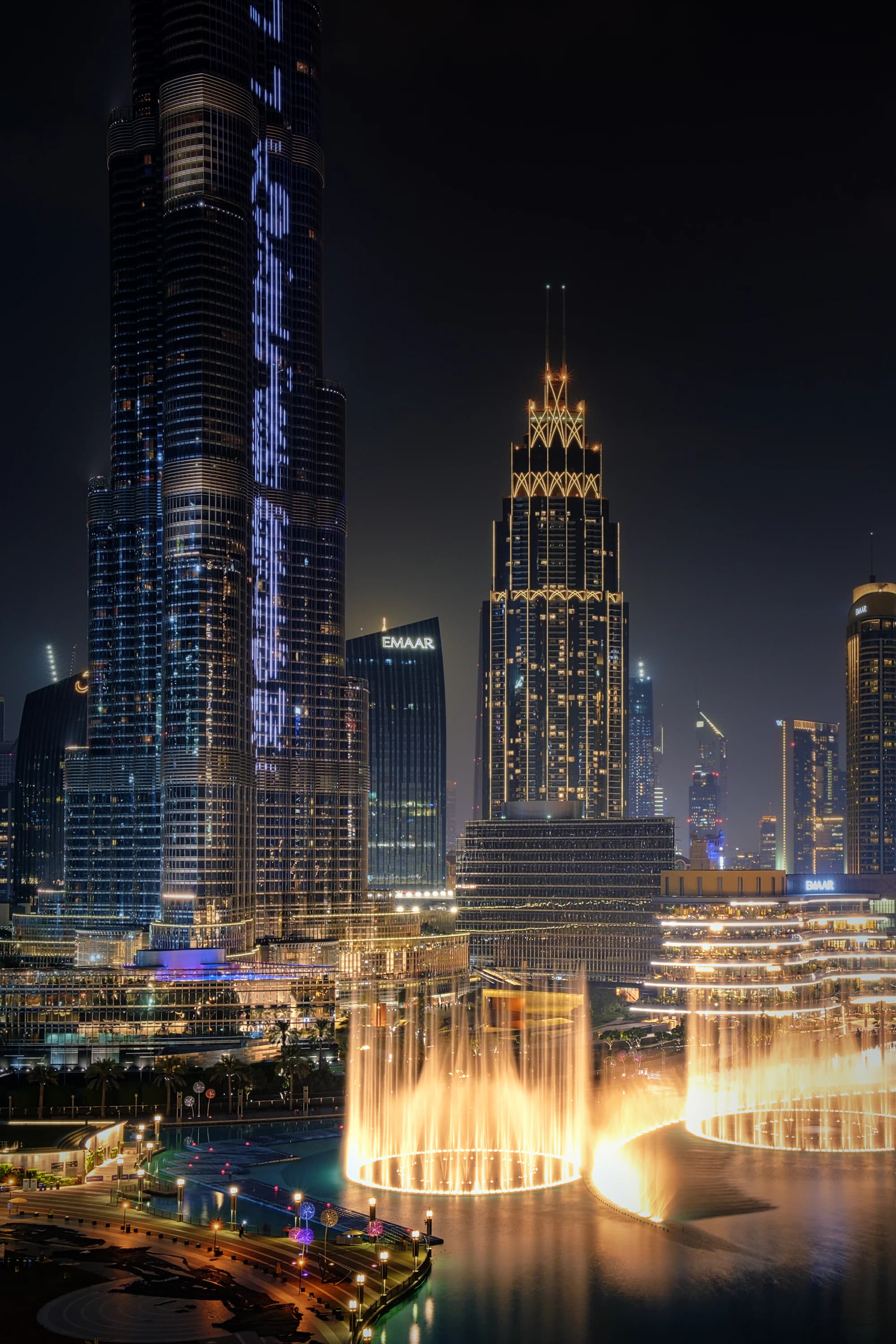 The Burj Khalifa above the lit-up Dubai Fountain at night