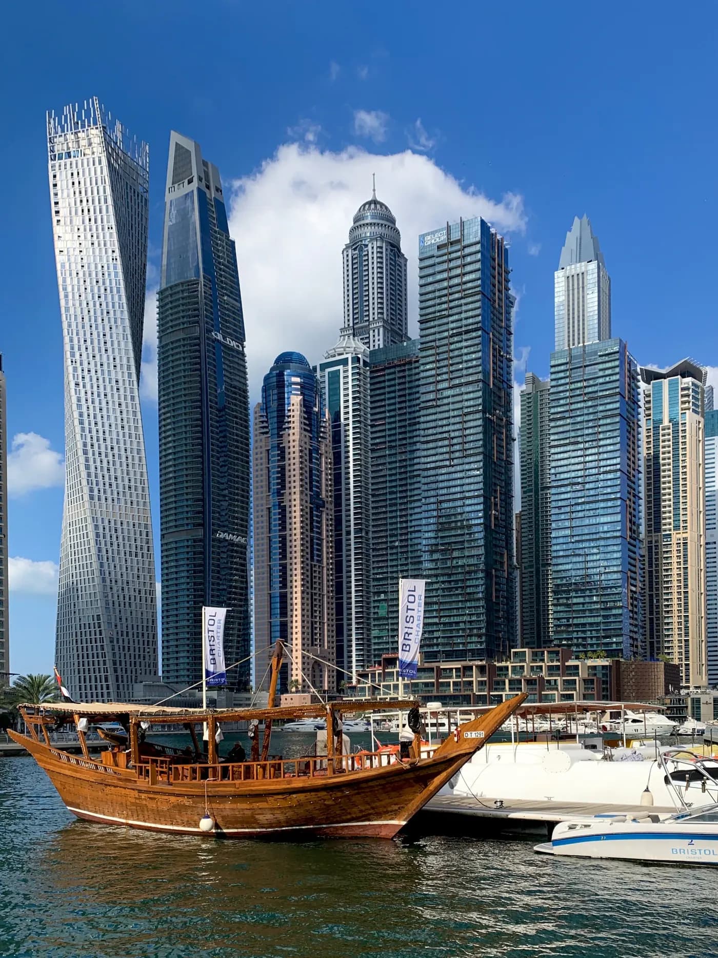 A wooden dhow moored among the towers of Dubai Marina
