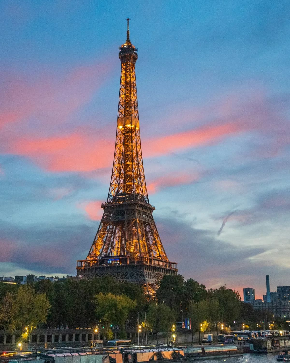 The Eiffel Tower lit up against a pink sunset sky, Paris