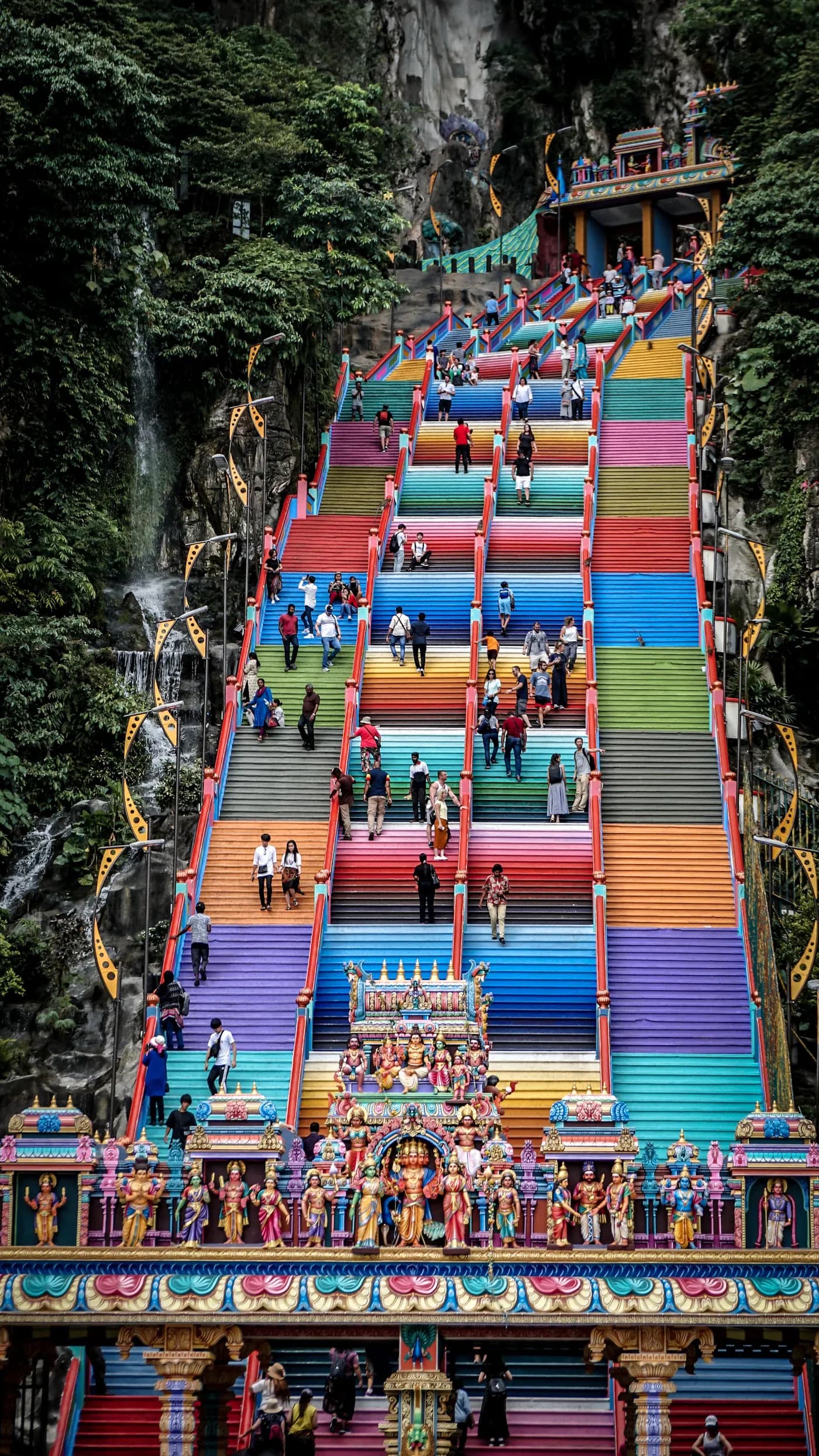 Visitors climbing the rainbow-painted steps to Batu Caves
