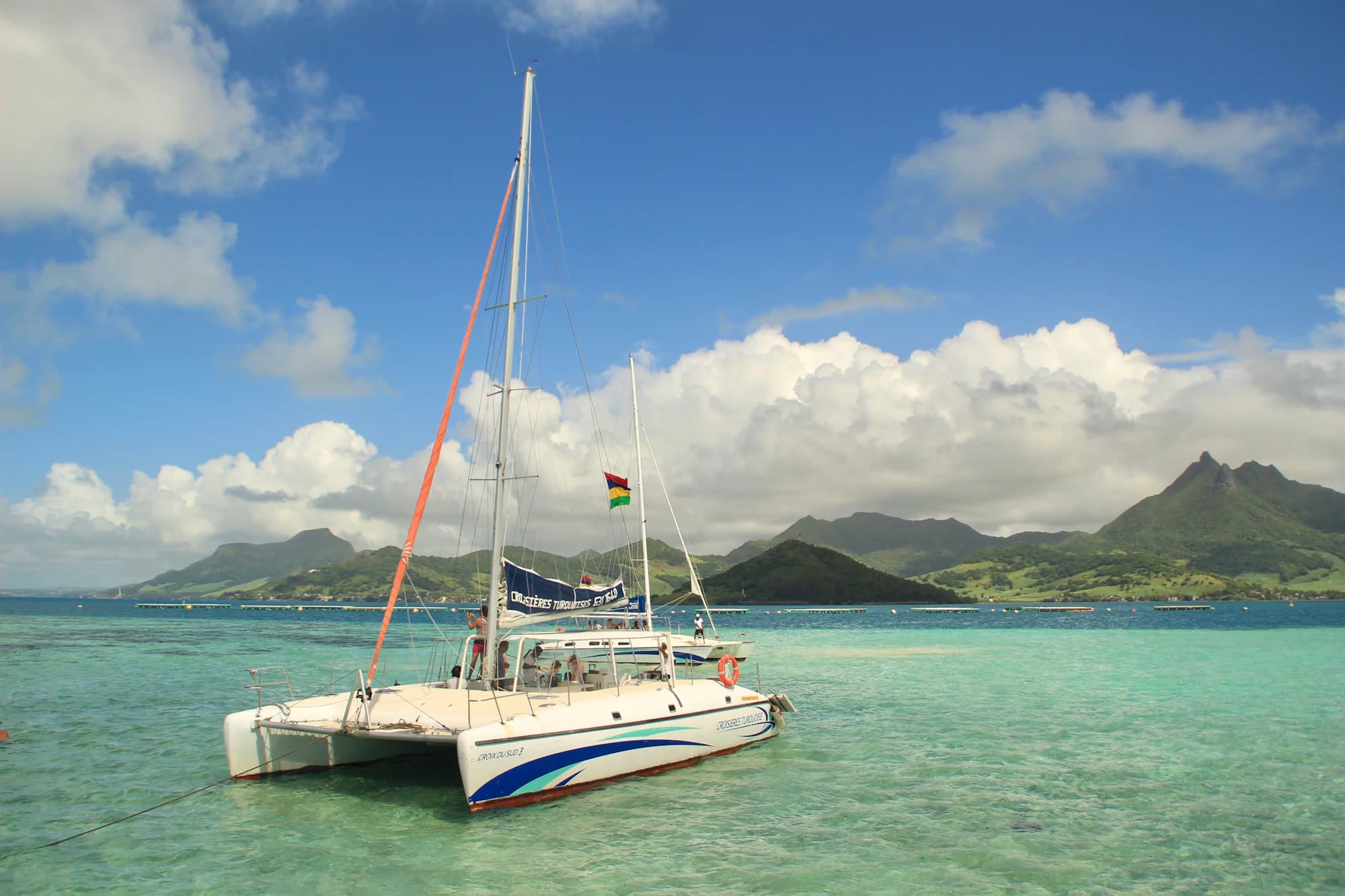 A catamaran anchored in a turquoise Mauritius lagoon