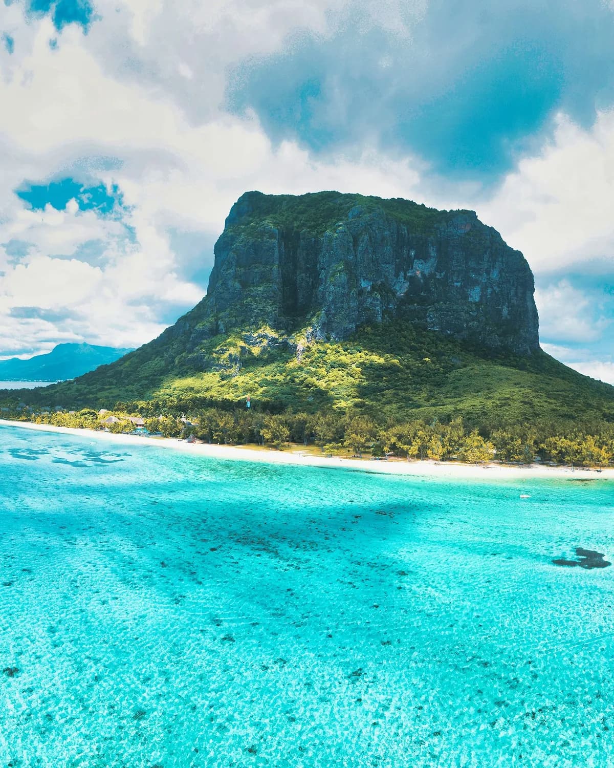 Le Morne Brabant rising above a white beach and a turquoise lagoon, Mauritius