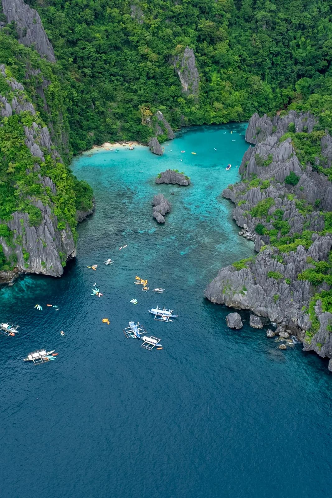 Boats in a lagoon between limestone cliffs, Palawan