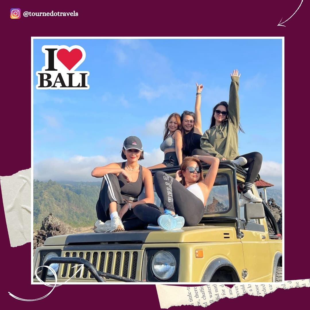 Friends with arms up on a jeep, Mt Batur, Bali