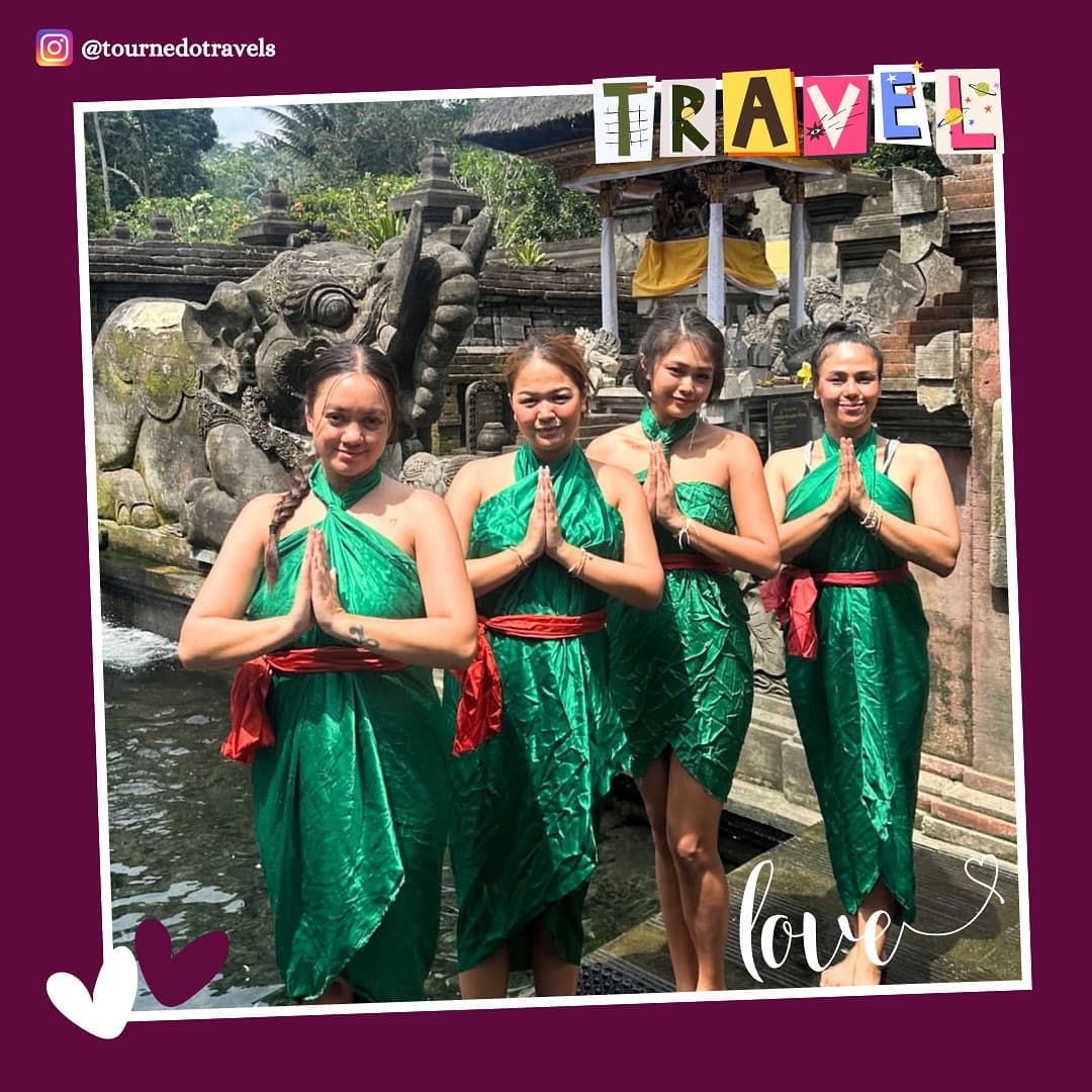 Four friends in green sarongs at a temple, Bali