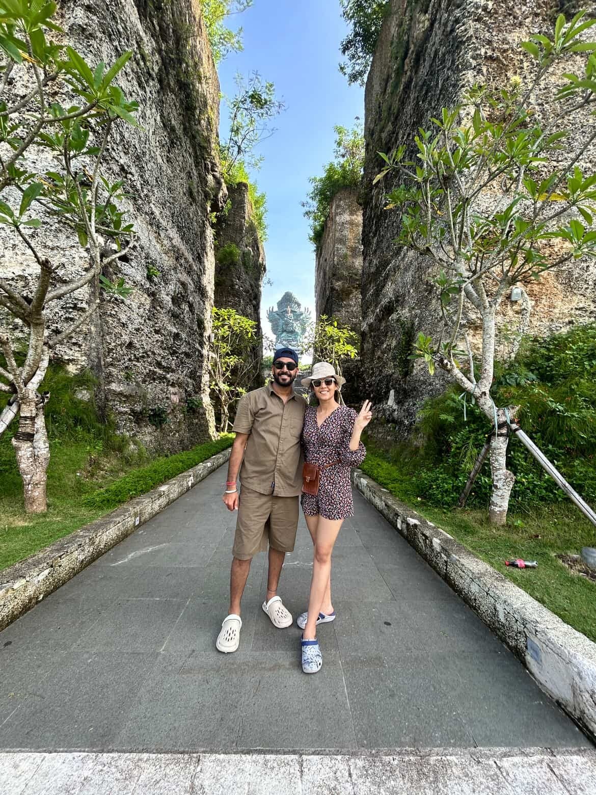 A couple on a path between limestone walls, Bali