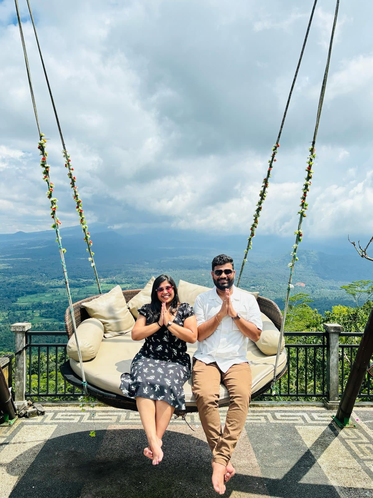 A couple on a swing seat above the valley, Bali