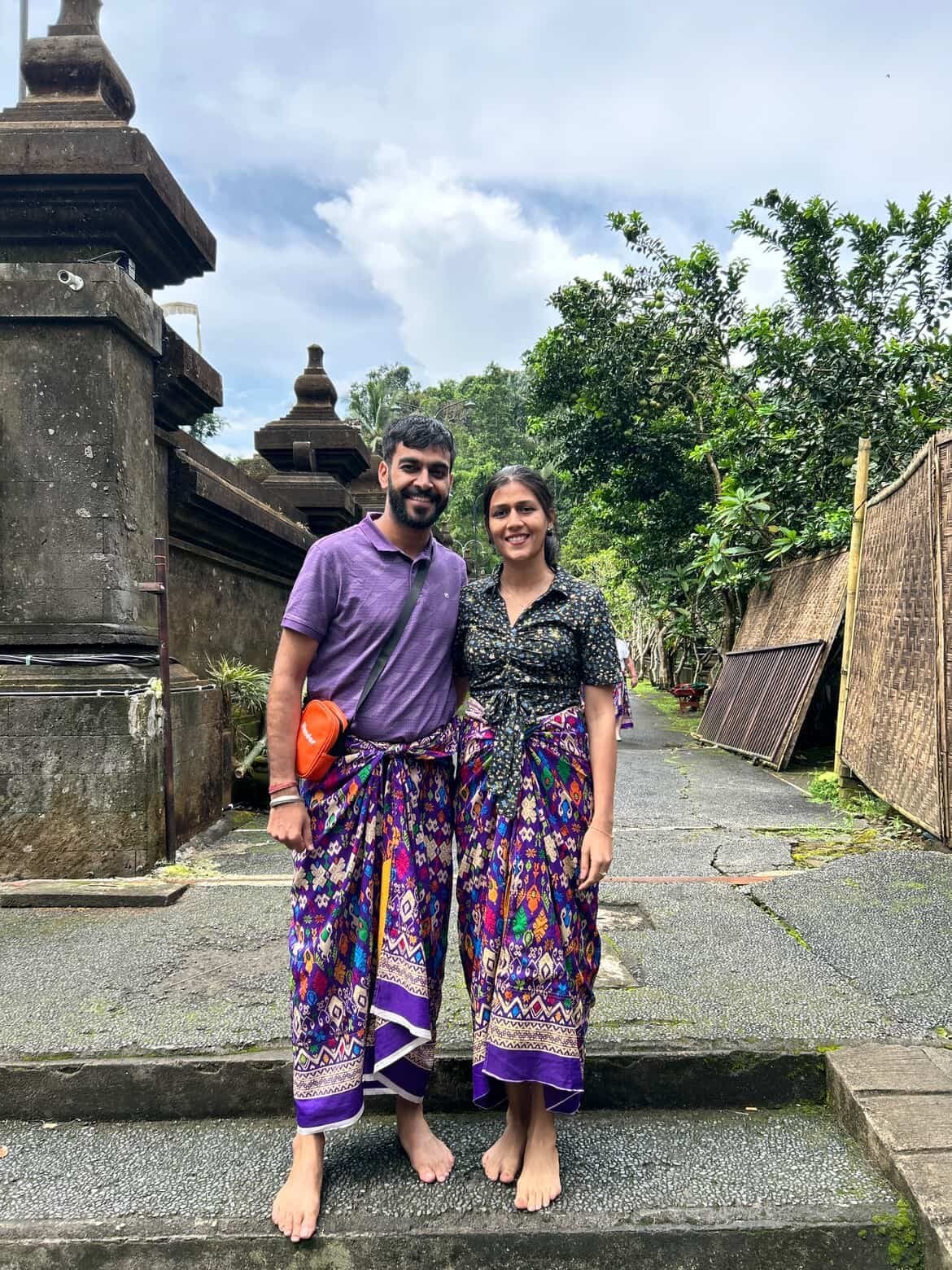 A couple in sarongs at a temple in Bali