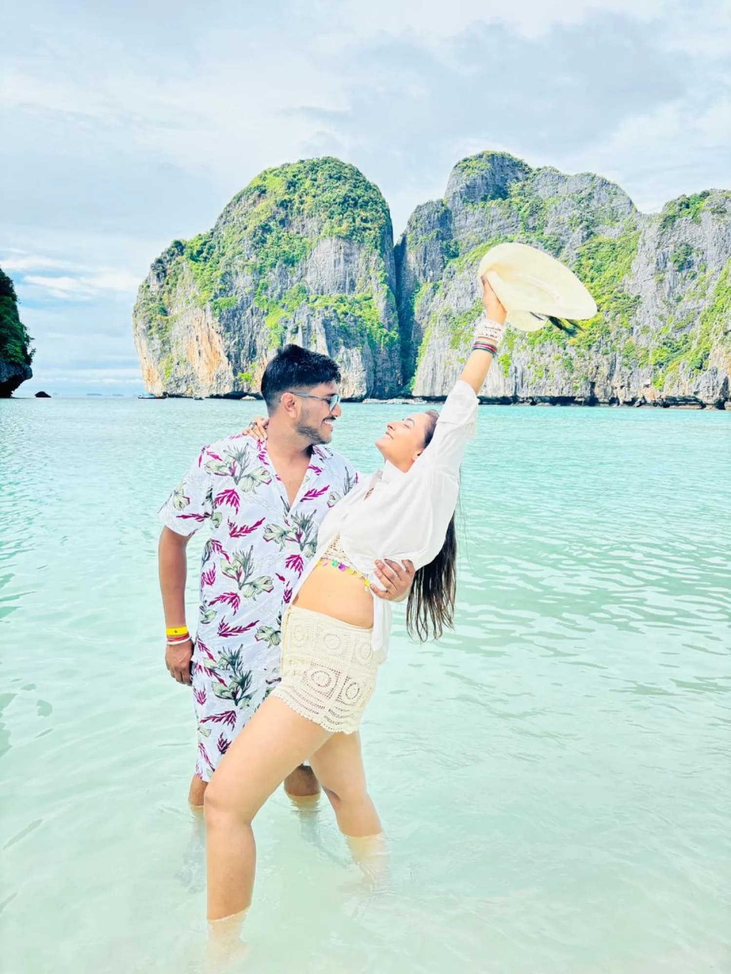 A couple in the shallows at Maya Bay, Thailand