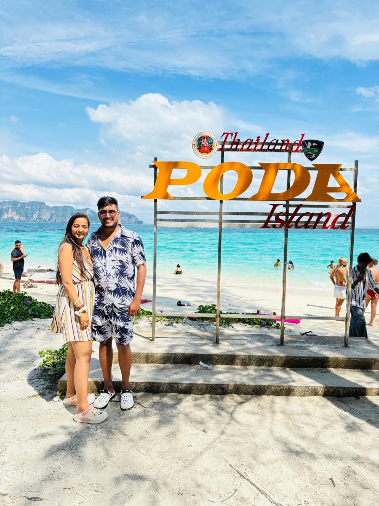 A couple at the Poda Island sign, Krabi