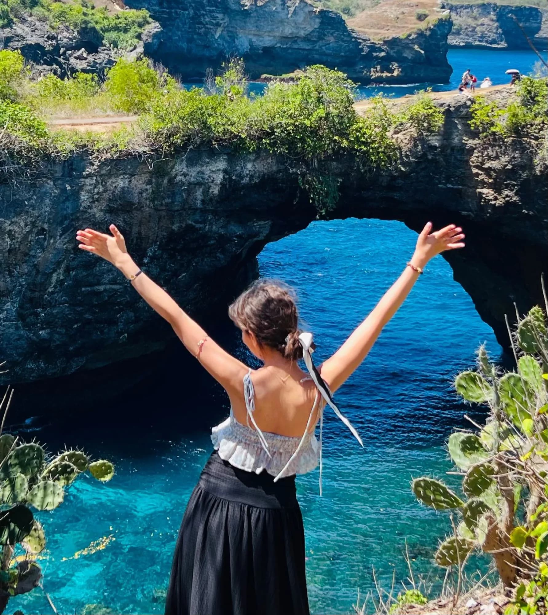 Arms up above Broken Beach, Nusa Penida, Bali