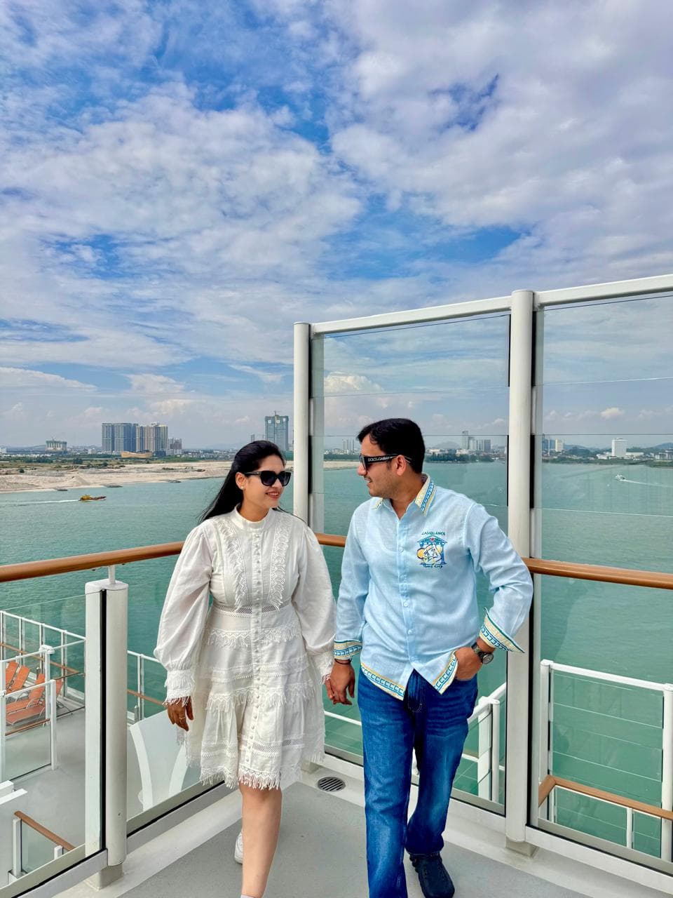 A couple on a cruise deck above the sea, Genting Dream