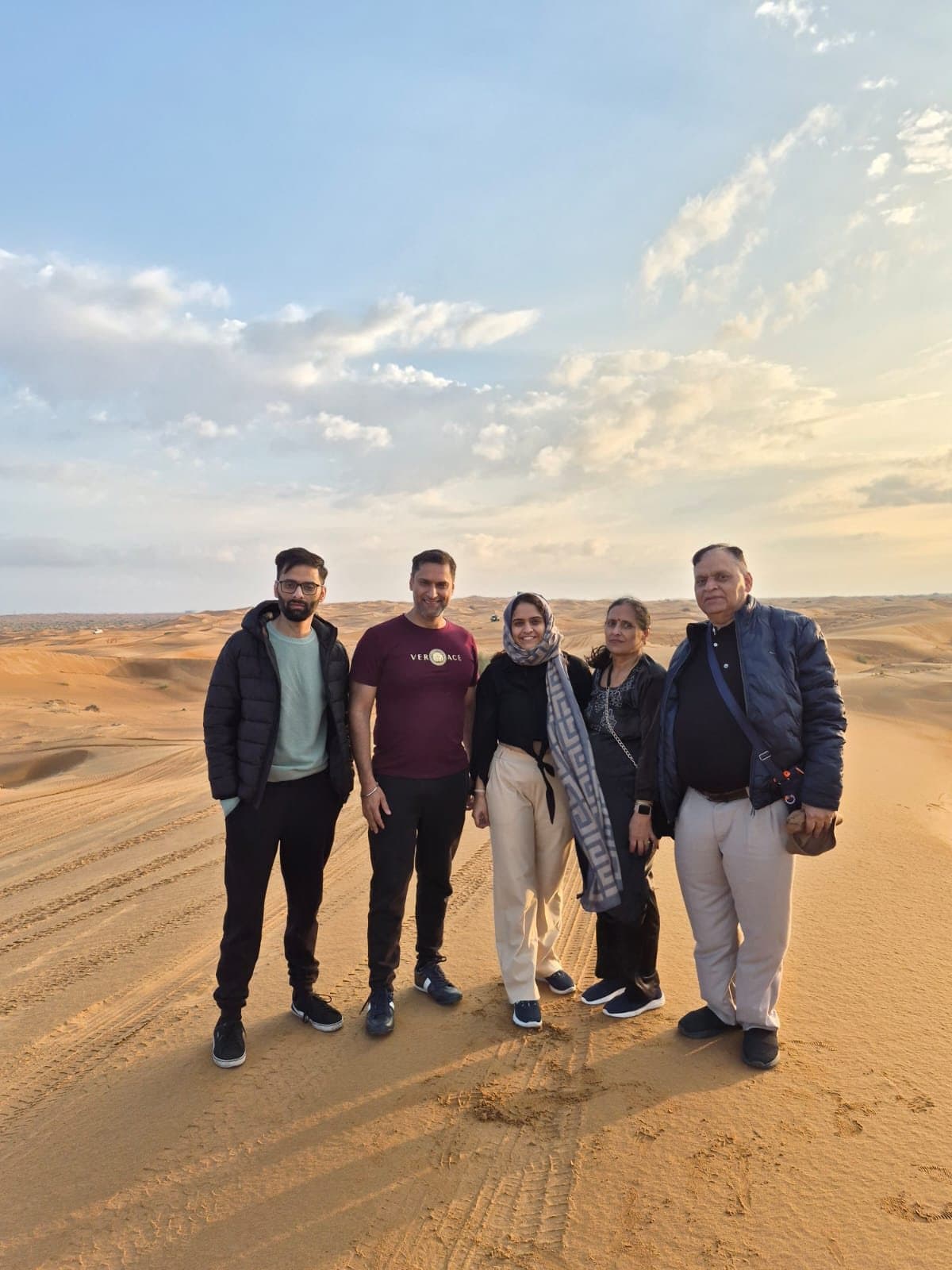 A family together on the desert dunes near Dubai