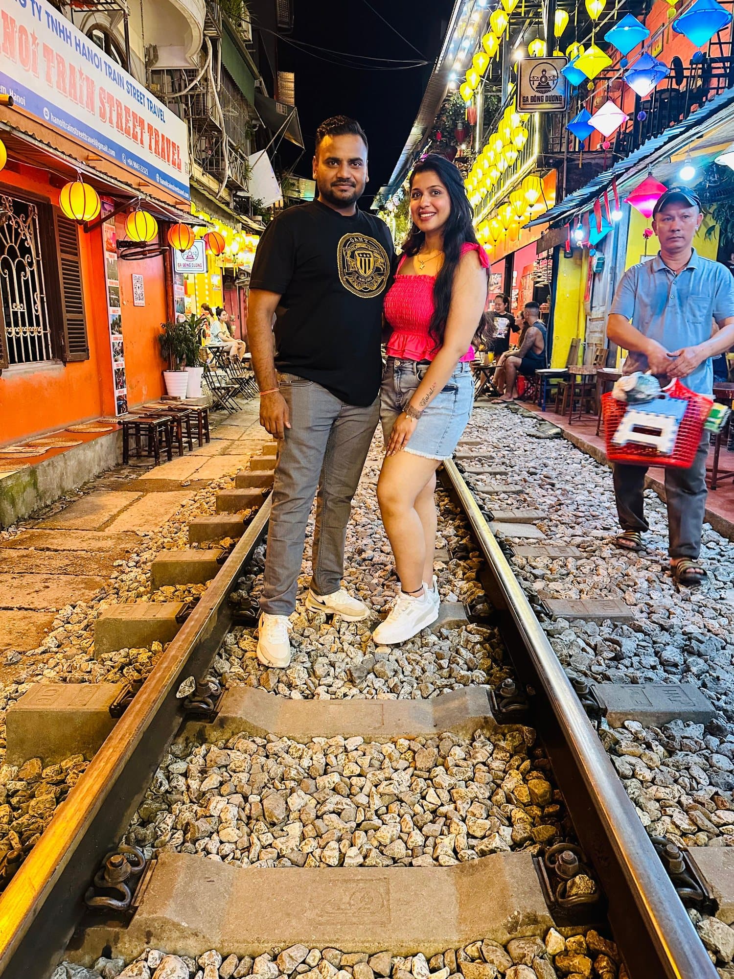 A couple on the tracks of Train Street, Hanoi