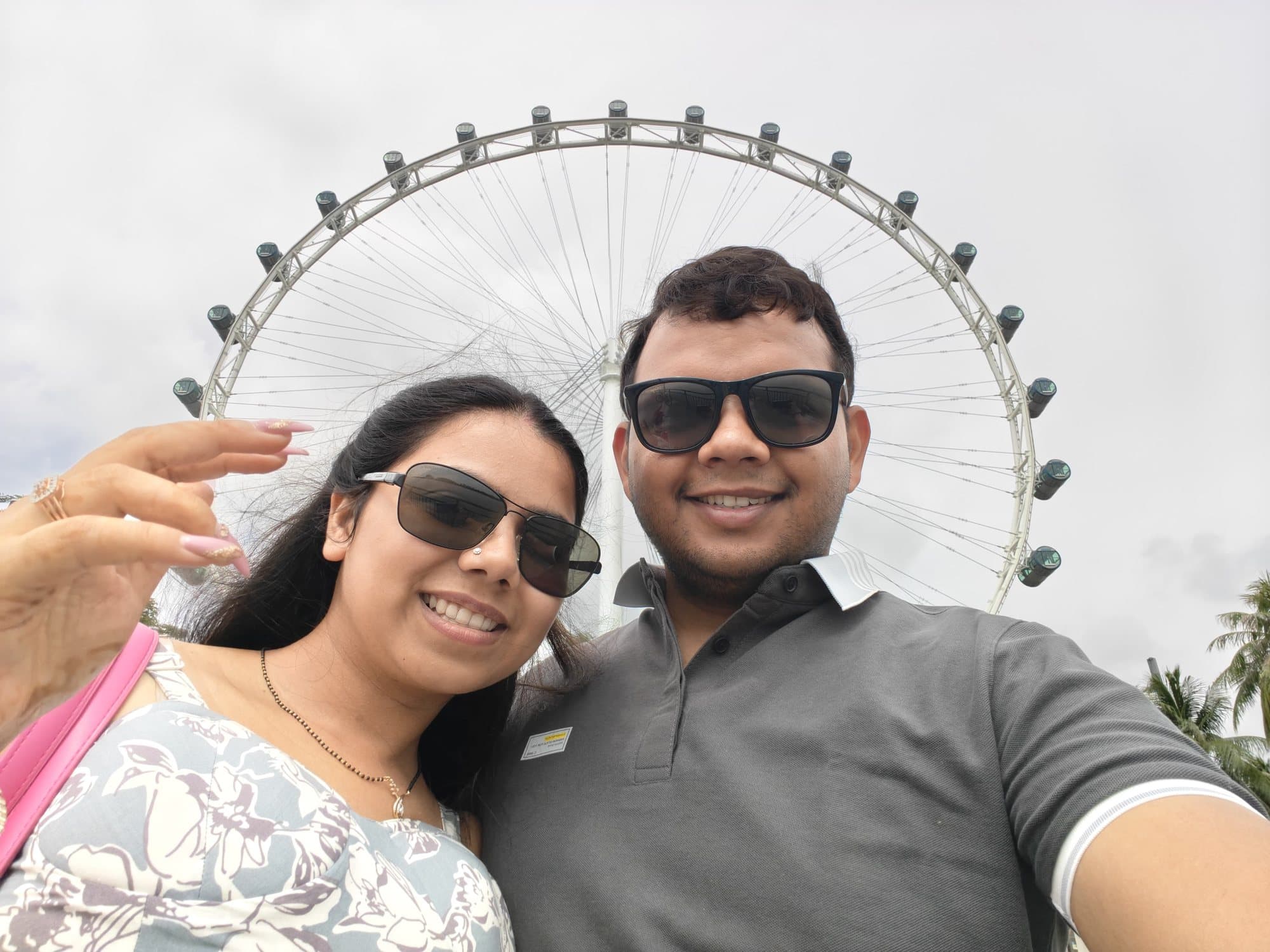 A couple's selfie in front of the Singapore Flyer