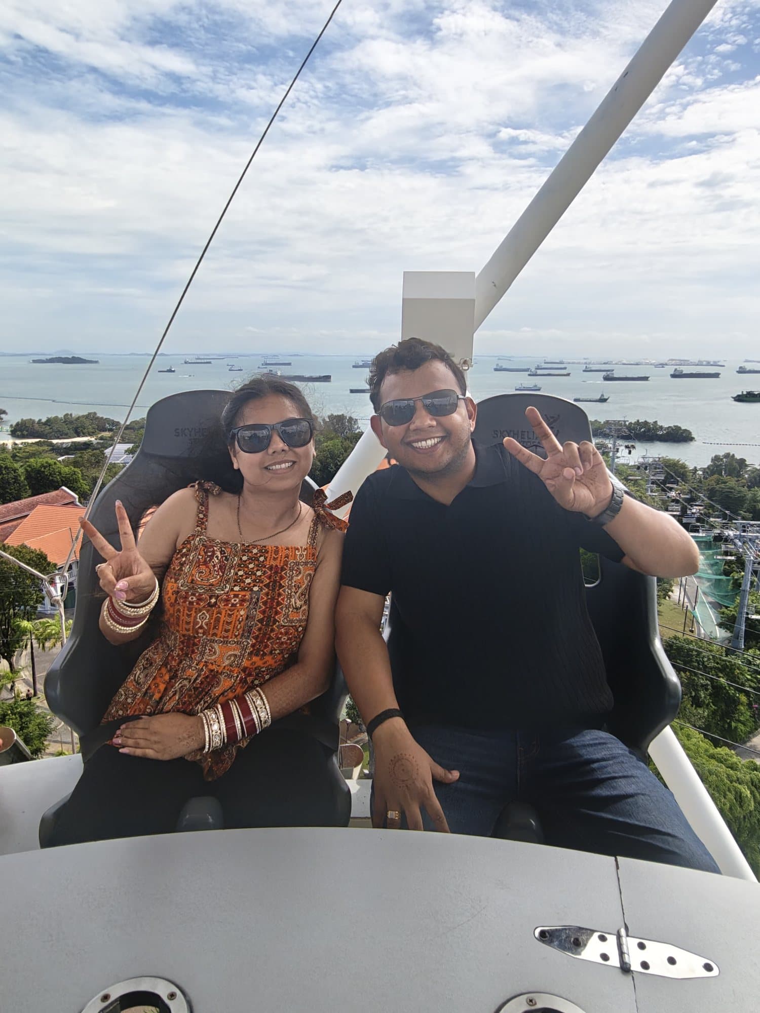 A couple on a ride high above the sea, Singapore