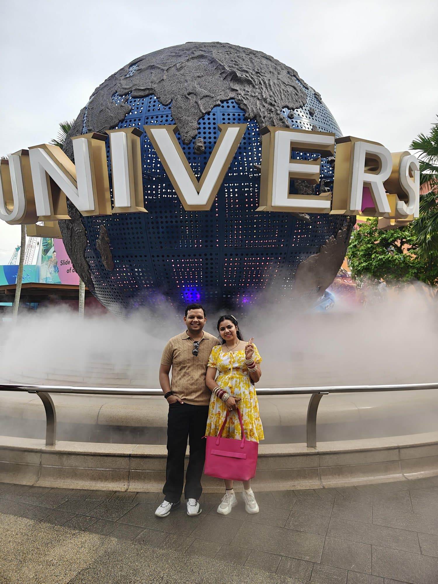 A couple at the Universal Studios globe, Sentosa