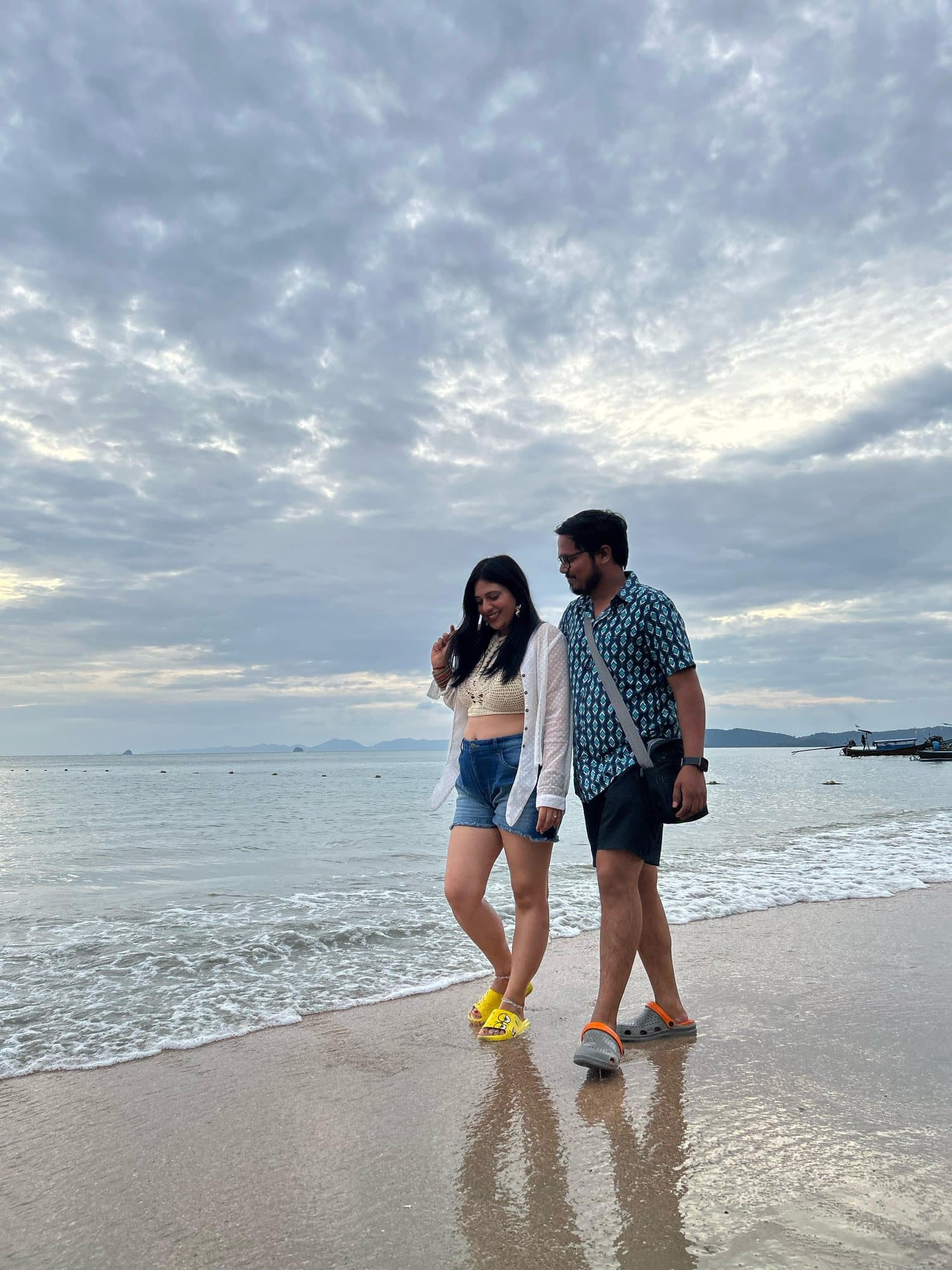 A couple walking along the shore, Thailand