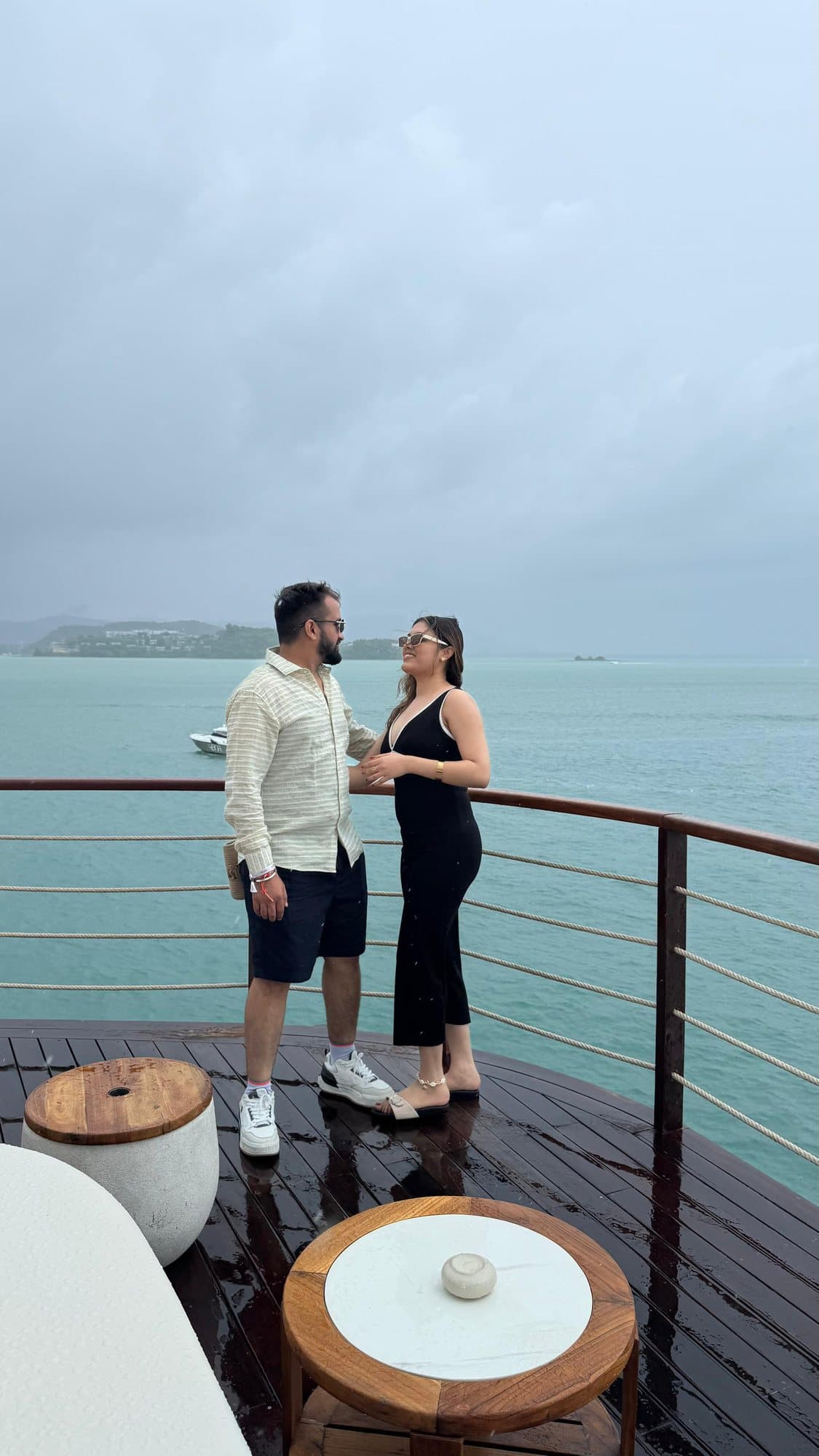 A couple on a deck above the sea, Thailand