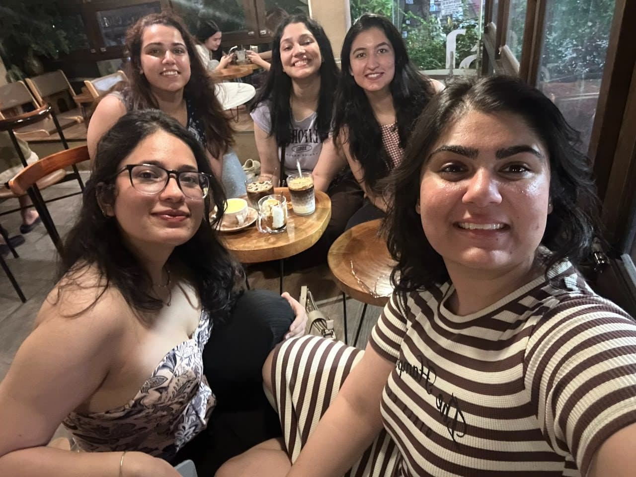 Friends' selfie over coffee at a café, Vietnam