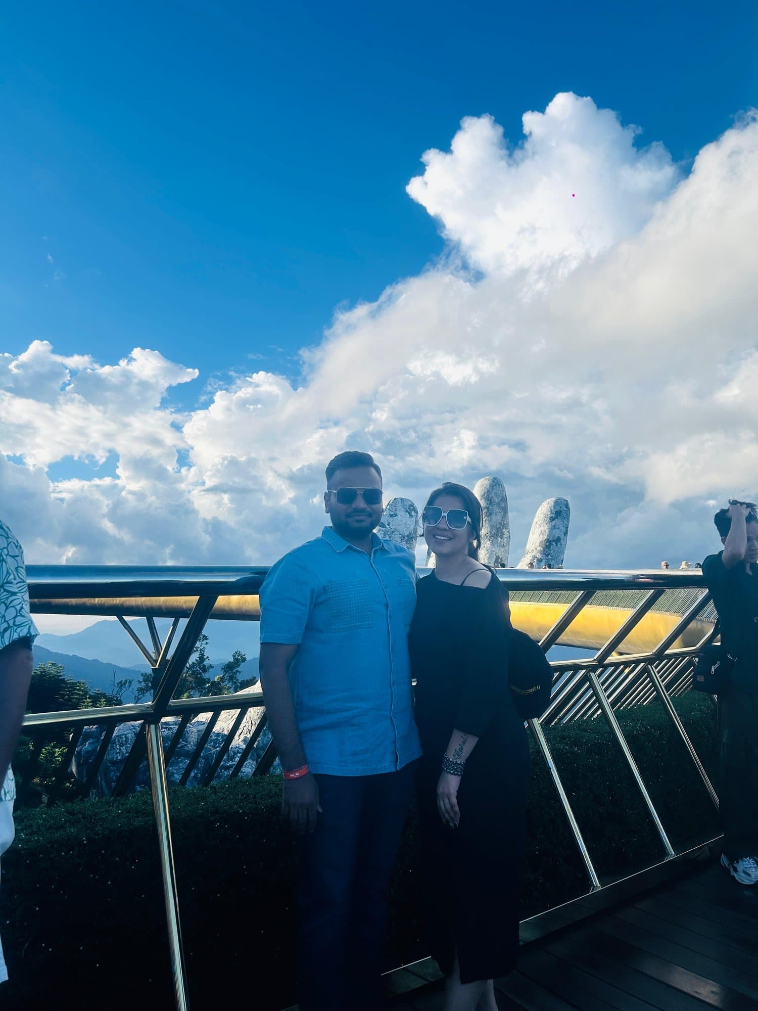 A couple on the Golden Bridge above the clouds, Ba Na Hills