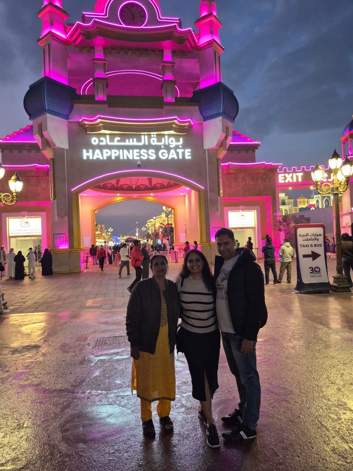 A family outside the gates of Global Village, Dubai, at night
