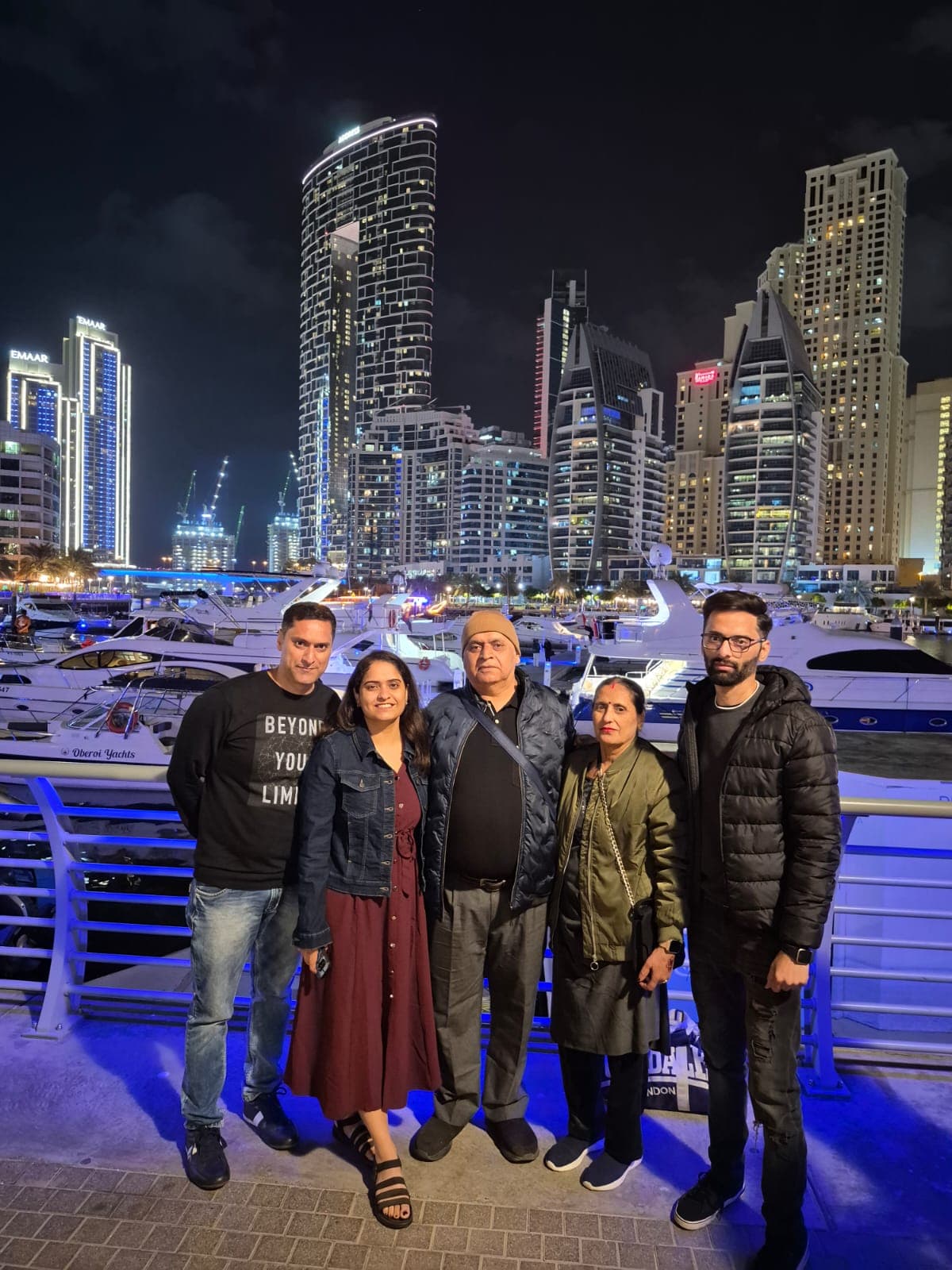 A family group at Dubai Marina at night