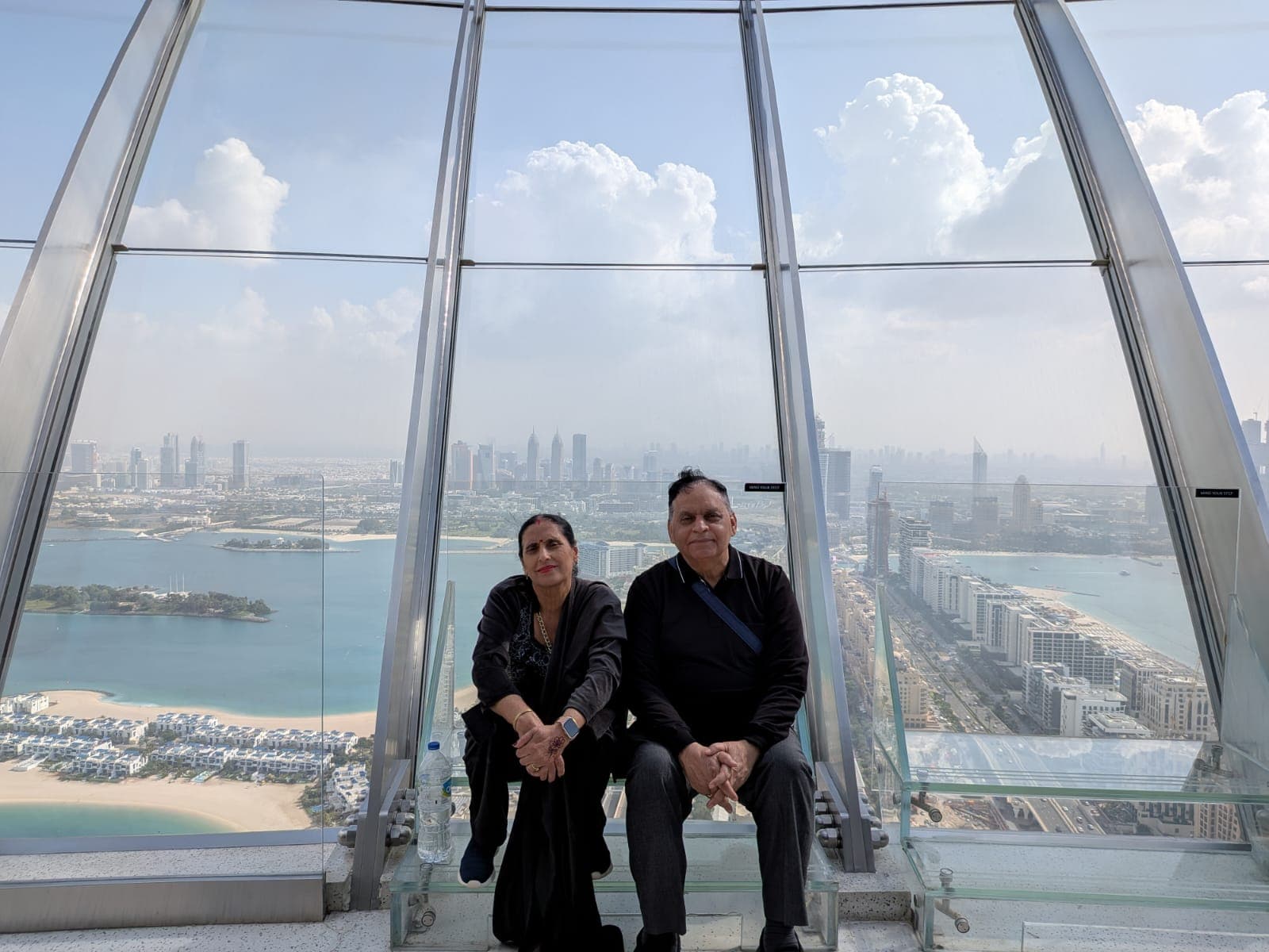 Parents at a sky deck above Dubai