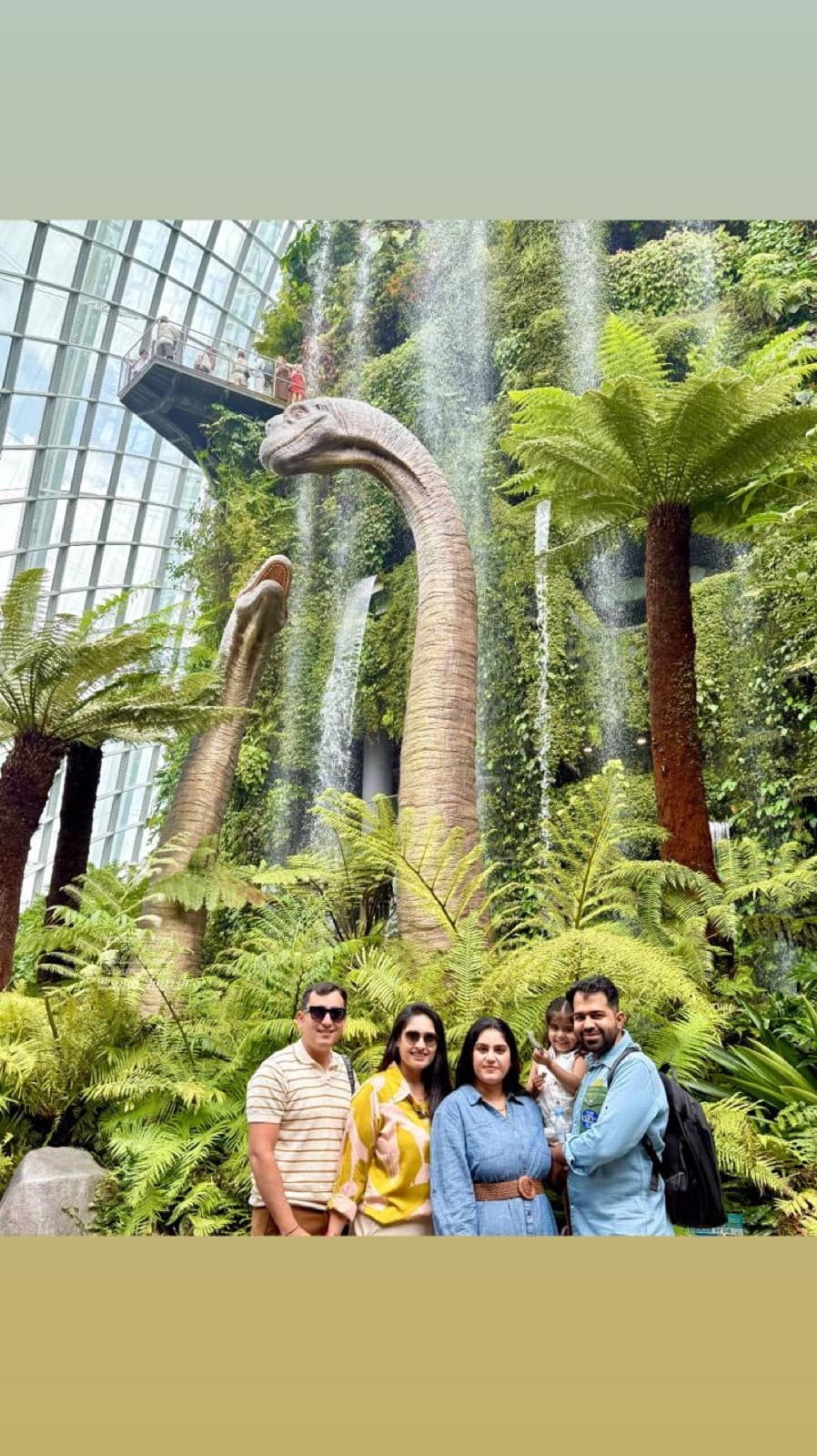 A family by the dinosaur in the Cloud Forest, Gardens by the Bay