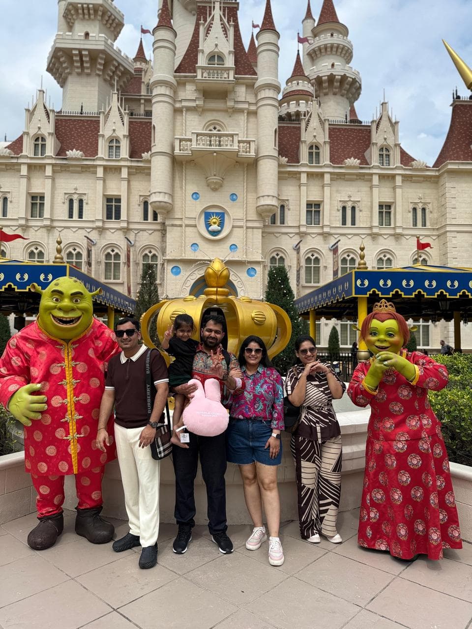 A family with Shrek and Fiona outside the castle at Universal Studios, Sentosa