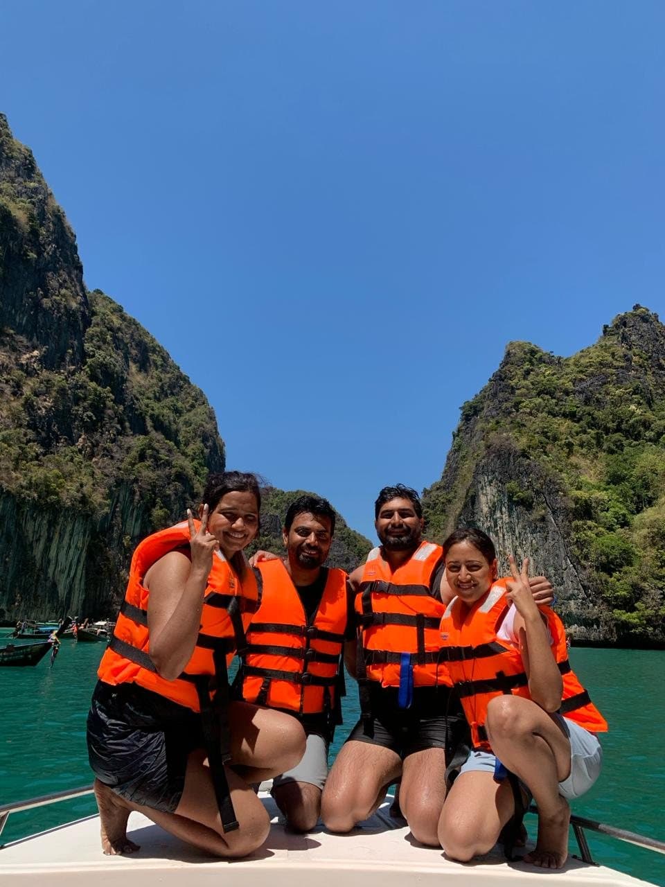 Friends in life jackets on a boat in a Phi Phi lagoon, Thailand
